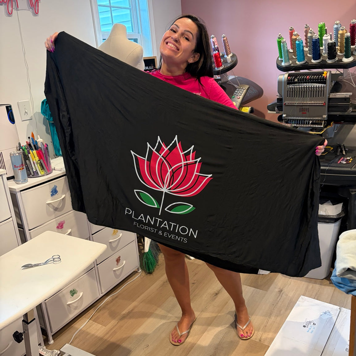 Amanda displaying a custom-printed business order in her workshop